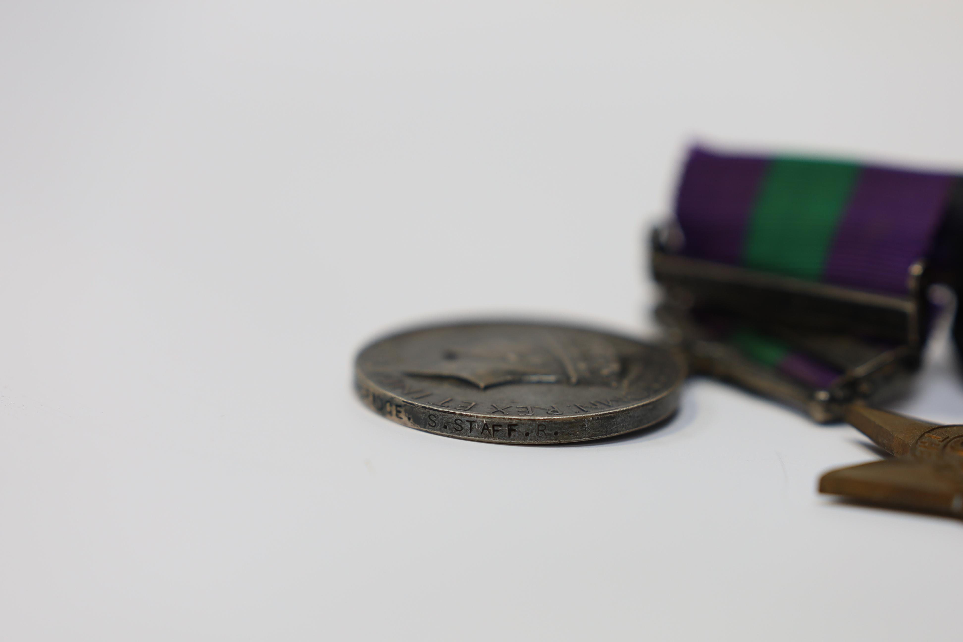 A WWII medal group awarded to Pte. J. Langridge S. Staff, comprising; a General Service Medal with two bars for Palestine and Palestine 1945-48, stamped to the edge with the recipient’s details, together with a 1939-45 S